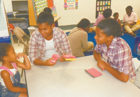 PFF twins, Kiana & Ka’Myia read to children at YMCA.