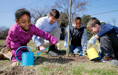 Zahria, Paulin Cheatham (Dominion spokesman for Project Plant It!), Caleigh and Ryan. The students are third-graders at John B. Cary Elementary