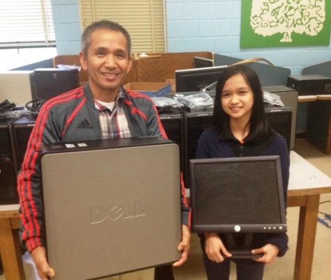 Father and daughter pick up refurbished computer.  Giello is a 5th grader at A.P. Hill Elementary School.  Gilbert Capate says, <a href=