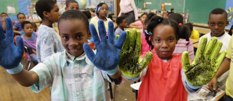 Students at Carver Elementary in the City of Richmond enjoy getting their hands dirty by planting redbud tree seedlings with Dominion's Project Plant It!